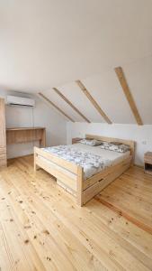 a bedroom with a large wooden bed in a room at River Valley Guest House in Foča