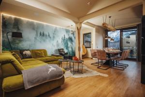 a living room with a couch and a table at JASNA NATUR Resort by the lake in Kranjska Gora