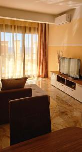 a living room with a couch and a flat screen tv at Apartment Sea Space 2 in Dobra Voda
