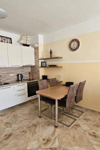 a kitchen with a wooden table and chairs at Apartment Sea Space 2 in Dobra Voda