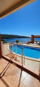 a balcony with a view of a swimming pool at Apartment Sea Space 2 in Dobra Voda