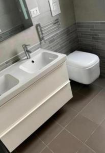 a bathroom with a white sink and a toilet at Stradone centrale in Vieste