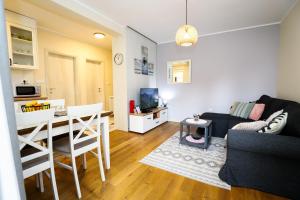 a living room with a couch and a table at BellaVita Apartman in Vrnjačka Banja