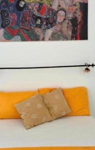 a bed with two pillows and a painting above it at Stradone centrale in Vieste