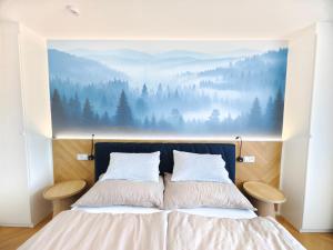 a bedroom with a large painting above a bed at Base Camp - Apartmán Klínovec in Kovářská