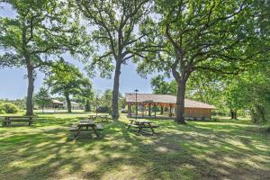 a group of picnic tables in a park with trees at Villa L'Andélu - Conciergerieland in Saint-Michel-Escalus +13 photos