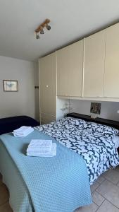 a bedroom with a blue and white bed with cabinets at Appartamento Nuvola Bianca 1 in Cesenatico