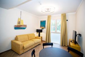 a living room with a couch and a table at Hotel Barcarola 2 in Marina di Campo