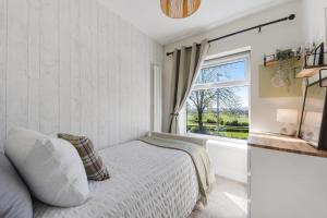 a bedroom with a bed and a window at Panoramic Sunset Views - Free Parking & Sleeps 5 in Heywood