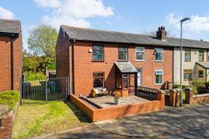 a brick house with a courtyard in front of it at Panoramic Sunset Views - Free Parking & Sleeps 5 in Heywood
