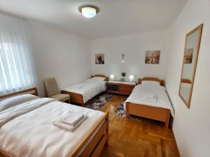 a room with two beds and a mirror at 2Hearts Apartment - Medjugorje in Međugorje