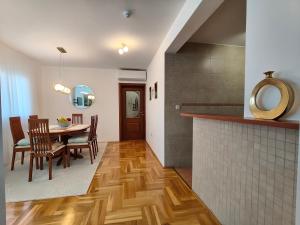 a kitchen and dining room with a table and chairs at 2Hearts Apartment - Medjugorje in Međugorje