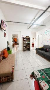 a living room with a couch and a table at Hostel & Coffe Bahia in Porto Alegre