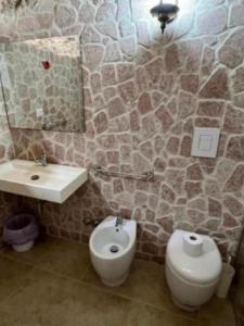 a bathroom with a sink and a toilet and a mirror at Stradone centrale in Vieste +2 photos