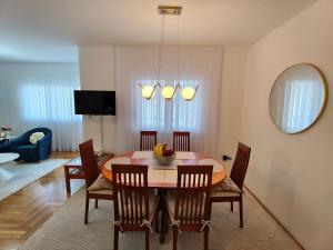 a dining room with a table with chairs and a mirror at 2Hearts Apartment - Medjugorje in Međugorje