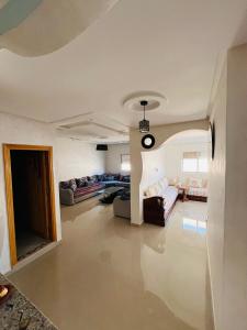 a living room with couches and a clock on the ceiling at Chez Yamaa in Oualidia