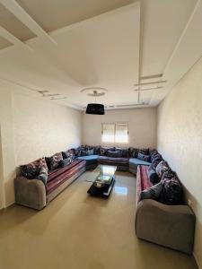 a large living room with couches and a table at Chez Yamaa in Oualidia