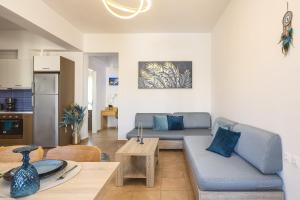 a living room with a couch and a table at Royal Touch Suite in Loutra