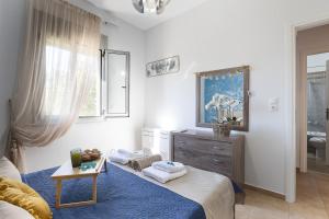 a bedroom with a bed and a dresser and a mirror at Royal Touch Suite in Loutra +71 photos