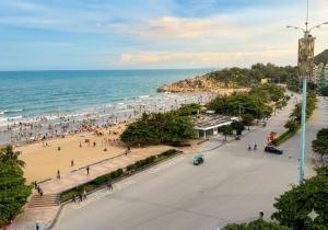 a view of a beach with people and the ocean at Khách sạn Hồ Gươm in Sầm Sơn +15 photos