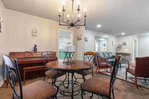a living room with a table and a piano at Nostalgic In Norwood in Birmingham