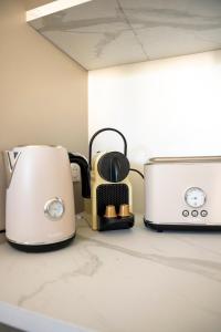 two toasters and a toaster on a counter at Studio Saint-Patrice - centre historique Bayeux in Bayeux