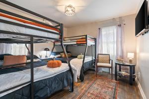 a bedroom with two bunk beds and a chair at Nostalgic In Norwood in Birmingham