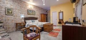 a bedroom with a bed in a brick wall at Cloudwalks Homestay in Kodaikānāl