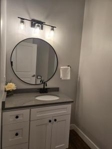 a bathroom with a sink and a mirror at Historic Federal Hill 1Br Loft apt with onsite Gym and Barbershop in Providence +14 photos