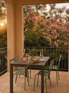 a wooden table and chairs on a patio at Villa familiale avec piscine hyper centre in Valras-Plage