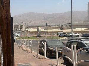 a row of cars parked next to a parking lot at ברזיליאנו - Braziliano in Eilat +2 photos