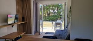 a living room with a door open to a patio at Résidence le safran in Erdeven