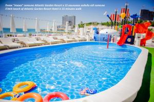 a pool on the roof of a hotel with a water park at Atlantic Garden Resort in Odesa