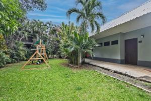 a house with a yard with a playground at Hotel Caña Brava Inn in Cañas