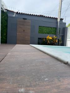 a house with a garage and a driveway at Pousada Pedra que Canta in Itamaracá