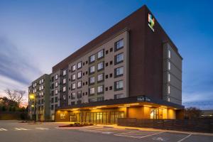 a large building with a sign on the side of it at EVEN Hotel Alpharetta - Avalon Area by IHG in Alpharetta