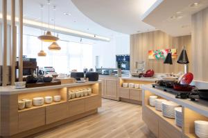 a kitchen with a counter with dishes on it at Richmond Hotel Aomori in Aomori