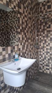 a bathroom with a sink and a mirror at Sea View Haven in Accra