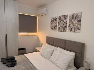 a bedroom with a bed and a blackboard on the wall at 11 Rose in Sannat