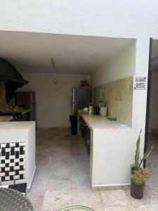 a kitchen with a counter and a refrigerator at Comodo Estudio 8 in El Gallinero