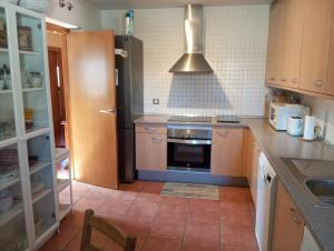 a kitchen with a sink and a stove top oven at Chalet independiente con vistas in Bustarviejo +24 photos