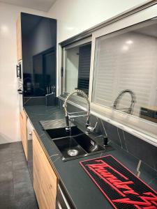 a kitchen with a sink and a window at Villa La Roca con casita independiente in Guadarrama