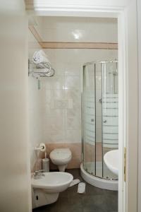 a bathroom with a shower and a toilet and a sink at B&B Metropols Sottomarina in Sottomarina +49 photos