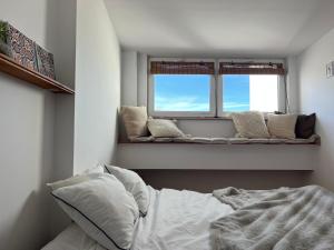 a bedroom with a bed and two windows at Gdynia Bulwar in Gdynia