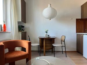 a kitchen with a table and chairs and a dining room at Gdynia Bulwar in Gdynia