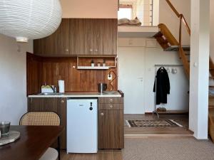 a kitchen with wooden cabinets and a white refrigerator at Gdynia Bulwar in Gdynia
