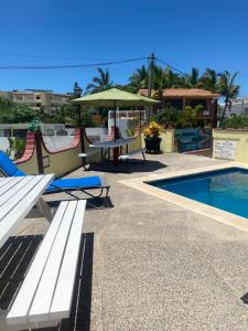 a patio with a table and chairs and a pool at Casitas Las Palmas - La Brisa in Punta Mita