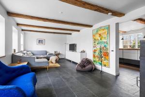 a living room with a blue couch and a tv at 20229-Samso-Byvejen-20 in Hårdmark
