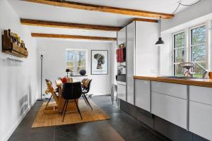 a kitchen with a table and a dining room at 20229-Samso-Byvejen-20 in Hårdmark