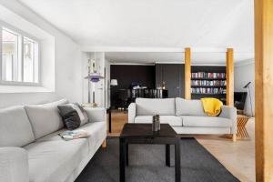 a living room with two white couches and a table at 20622-Samso-Skolebakkevej-38 in Brundby